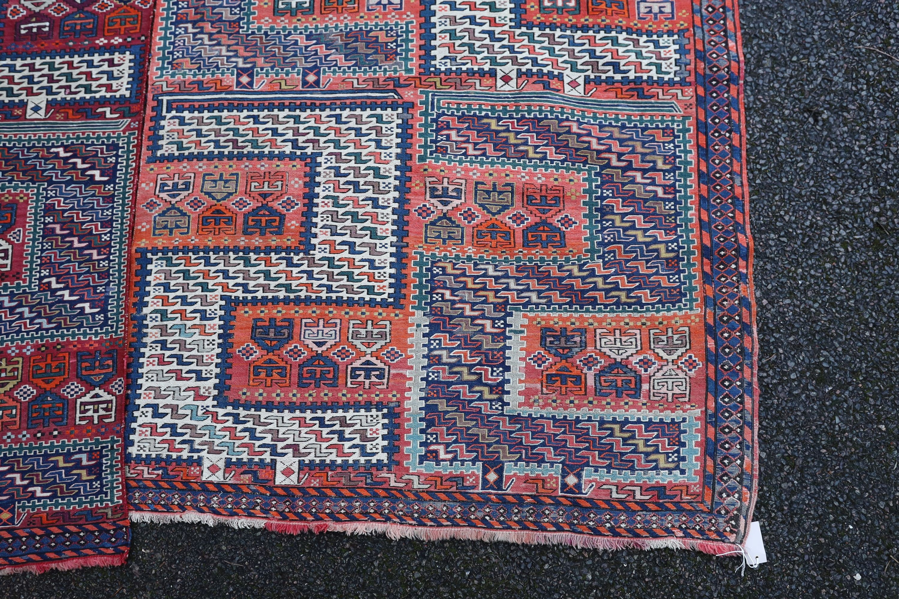 A Sumak weave 2-sectional carpet, combined dimension - 320 x 230cm.